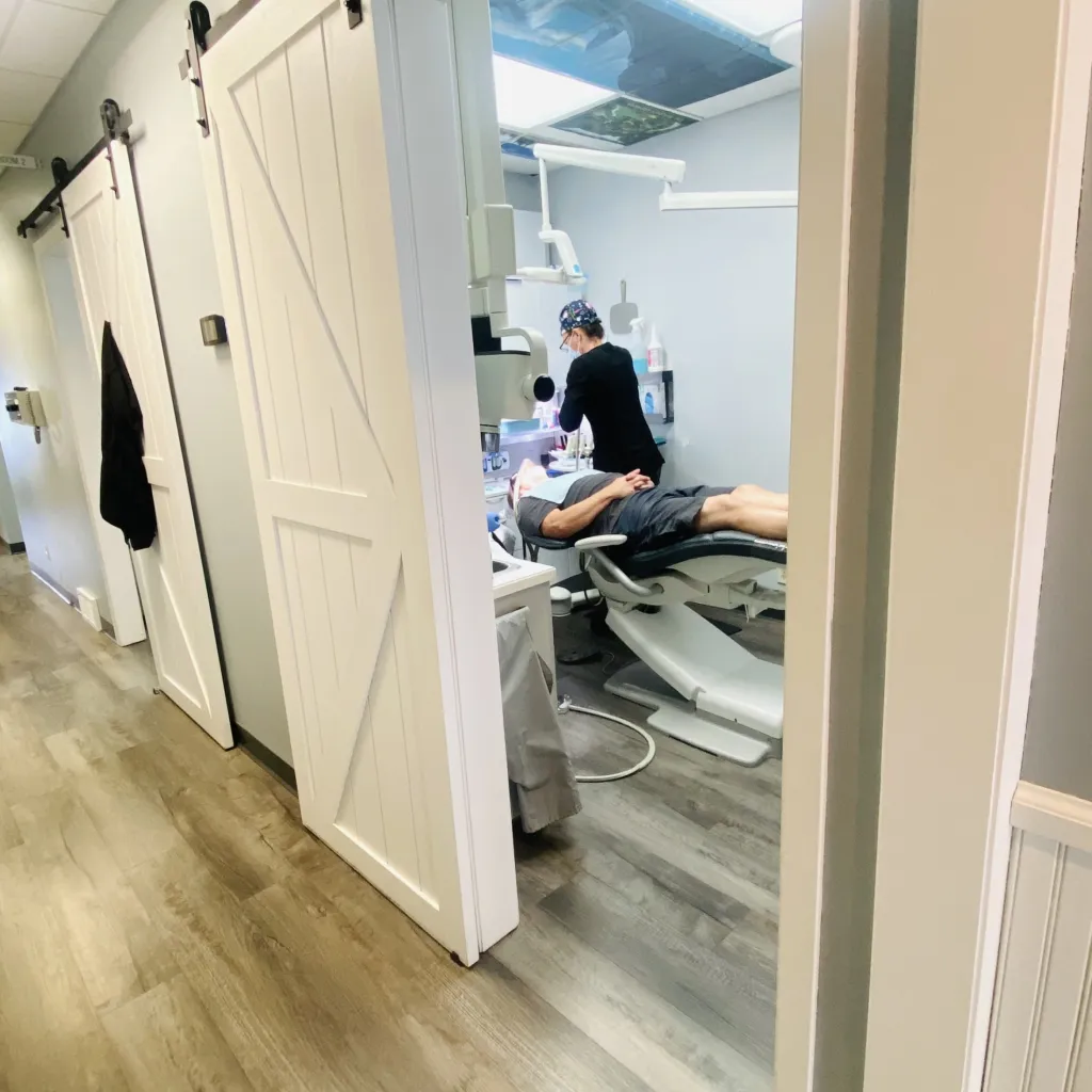 a dental assistant working on a patient.