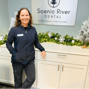 A team member standing infront of office signage